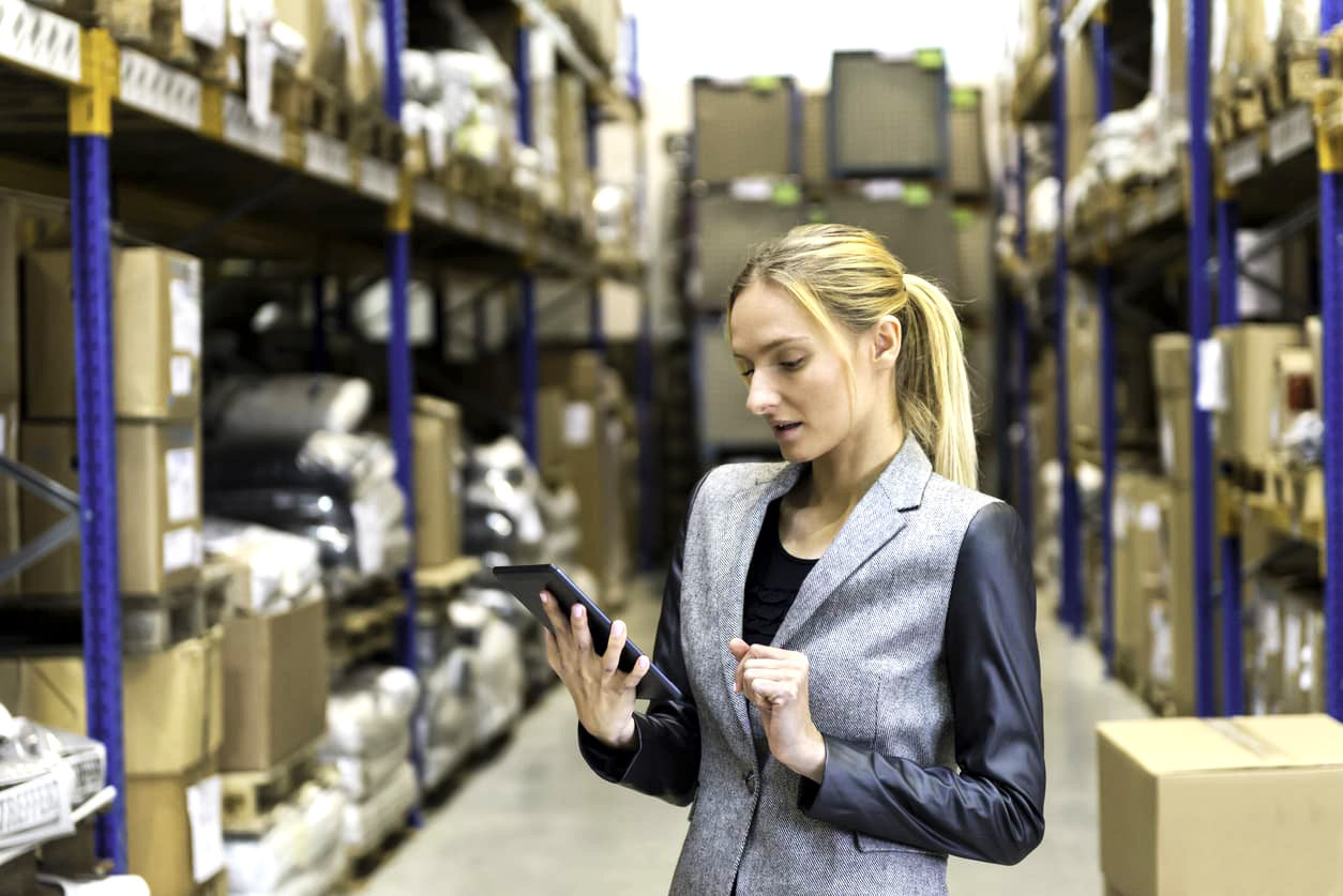 Female warehouse employee using an asset tracking system.